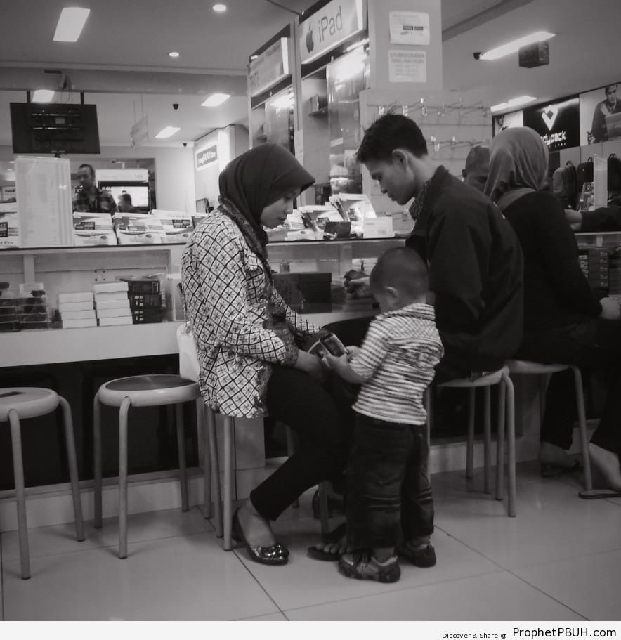 Muslim Family Browsing Electronic Gadgets - Islamic Black and White Photos -