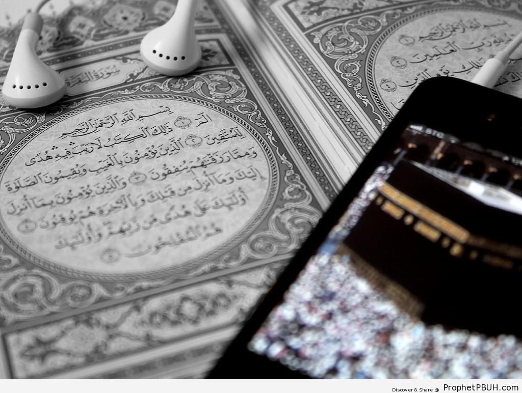 First Page of a Book of Quran, Earphones, and the Kaba on an iPhone Screen - al-Masjid al-Haram in Makkah, Saudi Arabia -Picture