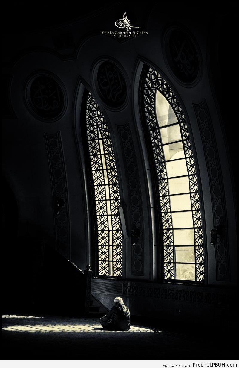 Light Falling on Man Sitting in Dark Mosque Prayer Hall - Islamic Architecture -Picture
