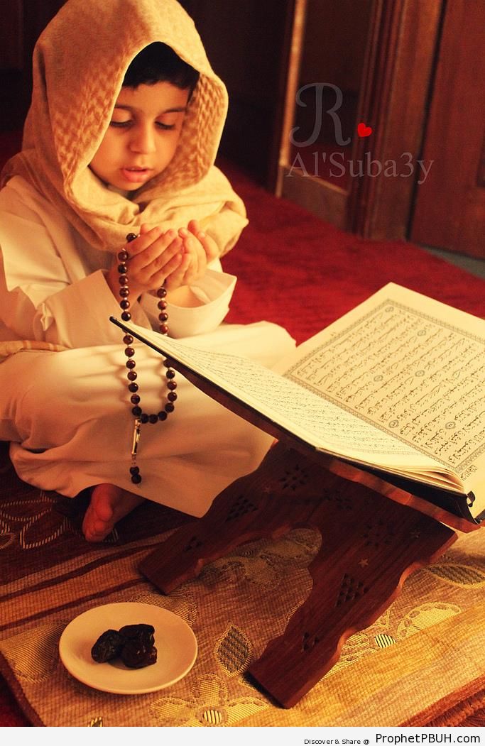 Little Boy Prays In Front of Open Mushaf - Mushaf Photos (Books of Quran) 